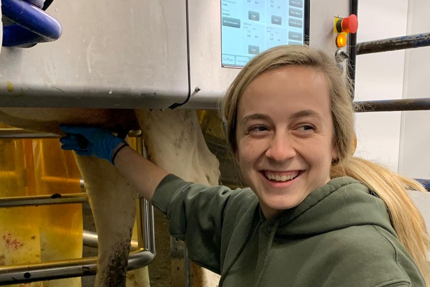 Student using robotic milking unit Student using robotic milking unit