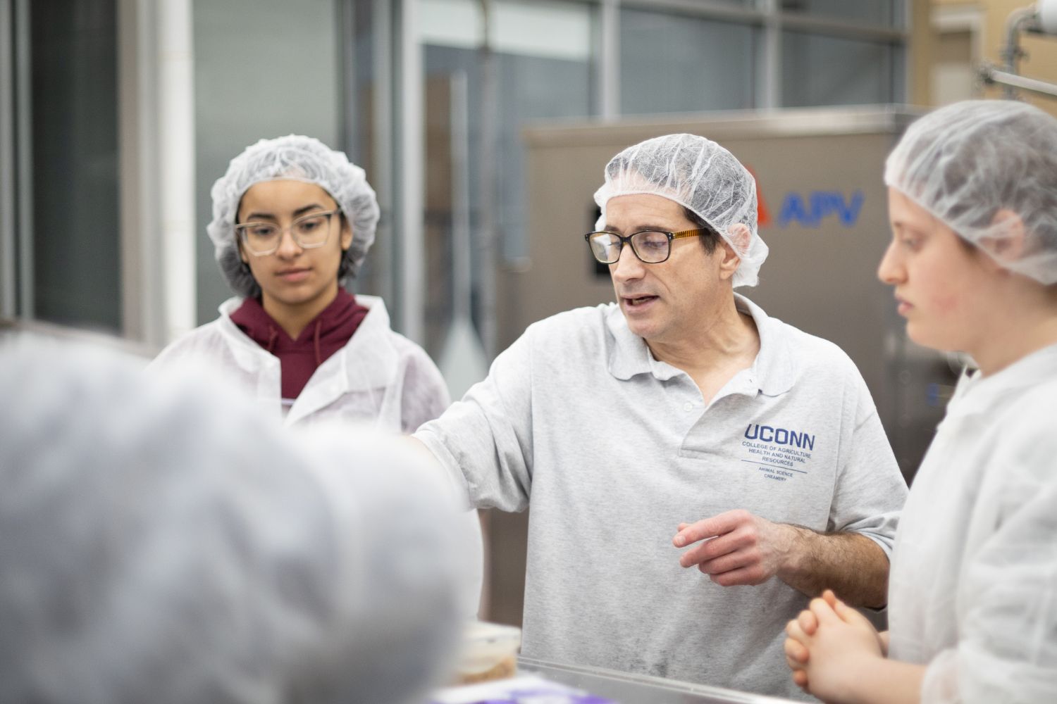 Students inside of the Creamery watching the ice cream production process Students inside of the Creamery watching the ice cream production process